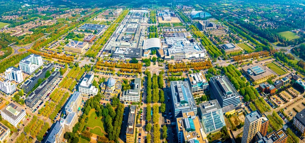 Aerial view of central Milton Keynes, with tree-lined boulevards between offices and shops